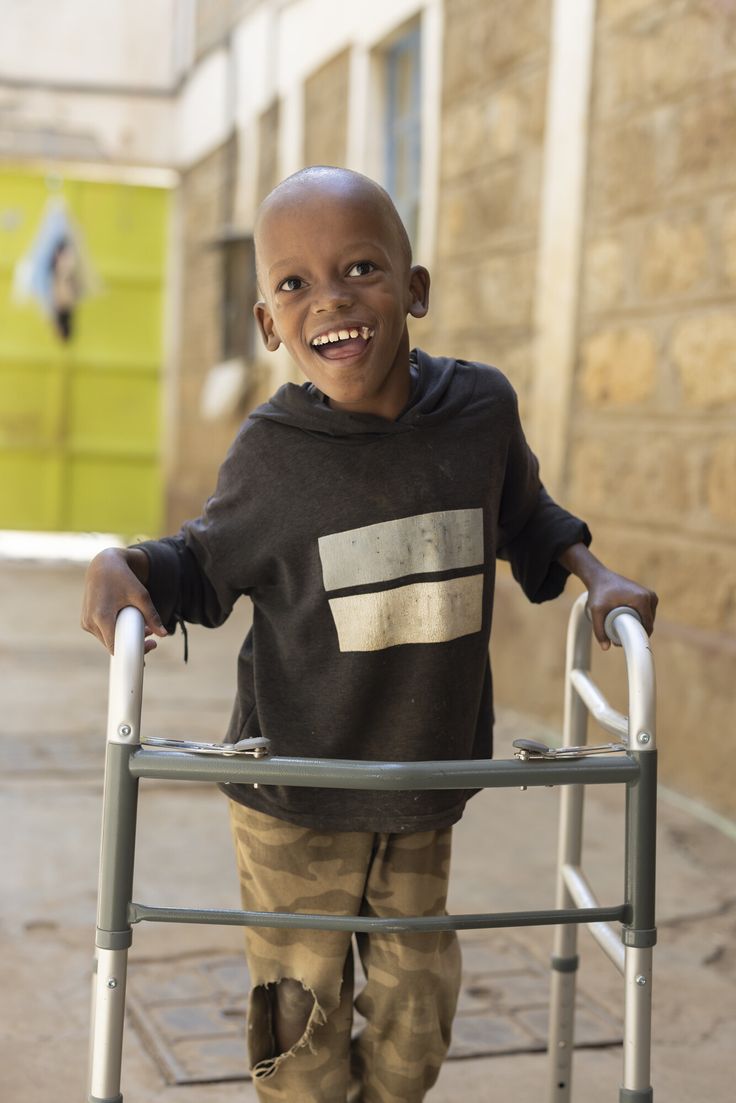 Gallery Image: Happy child with assistive walker.